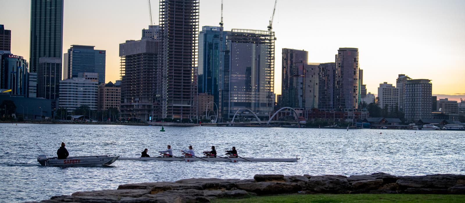 Rowing on the Swan River with the City of Perth cityscape