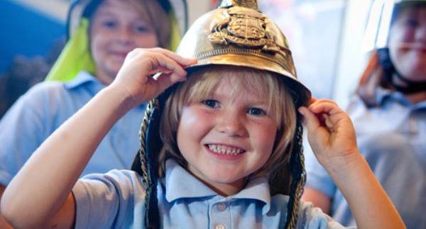 Child with fireman hat on
