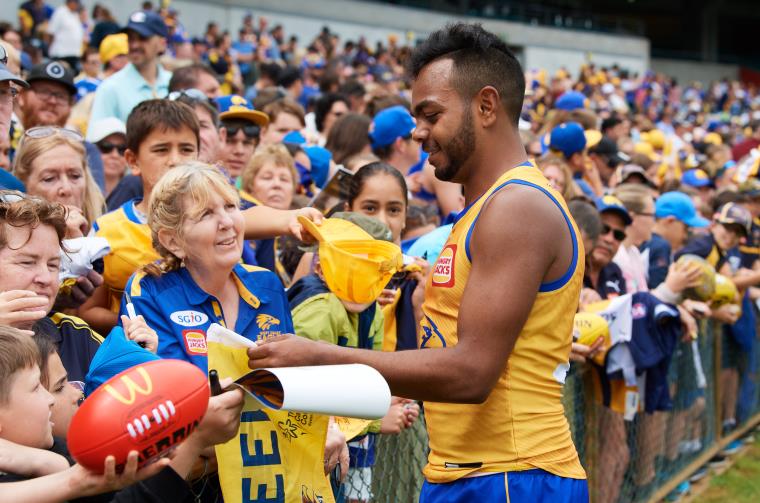 Fans of West Coast Eagles are greeted by the team. 