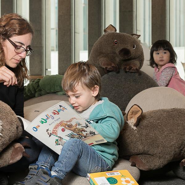 Mother and toddler reading book