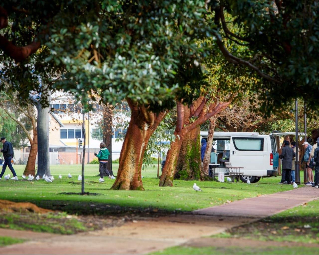 Mobile food van feeding homeless in park