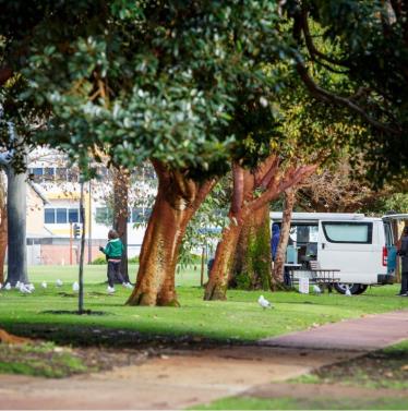 Mobile food van feeding homeless in park