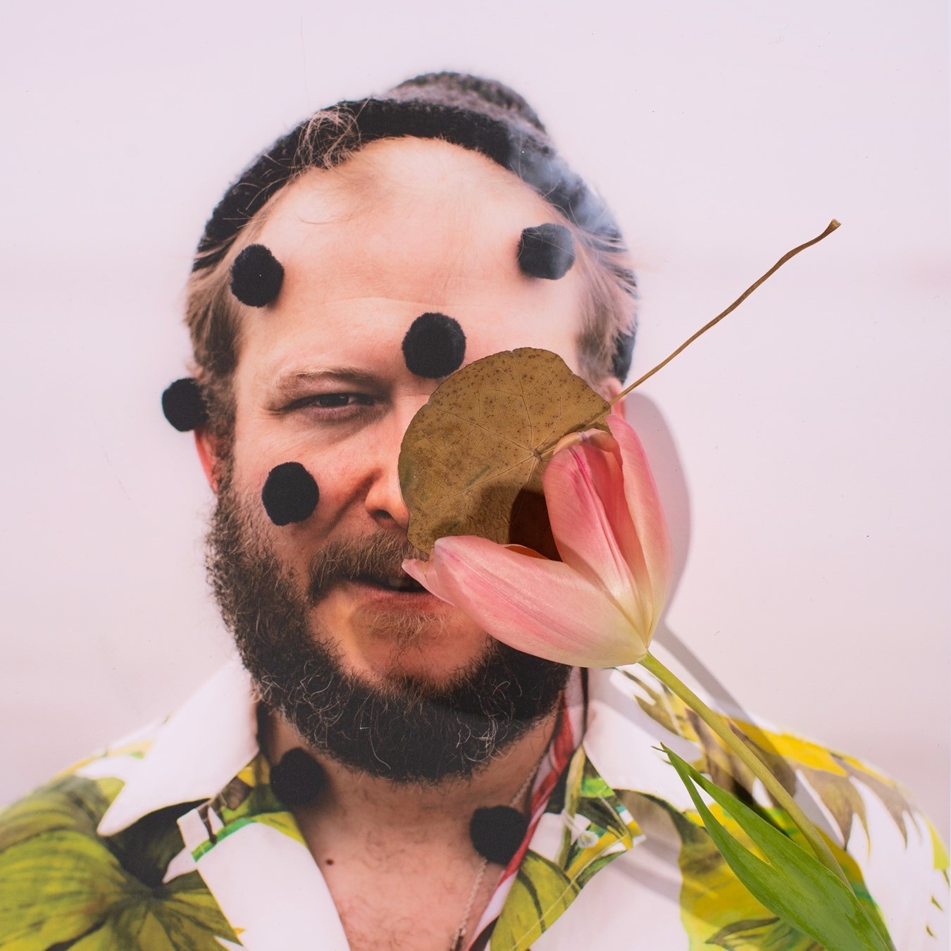 Close up of Bon Iver with flower in front of his face