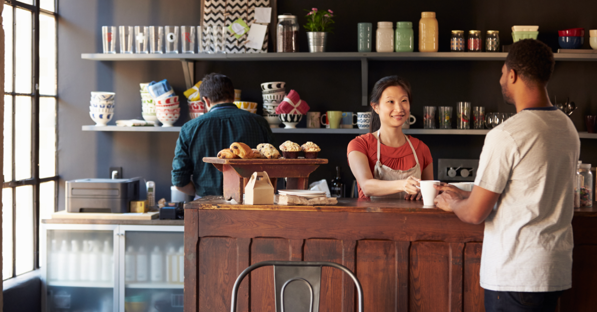 Women serving a customer coffee