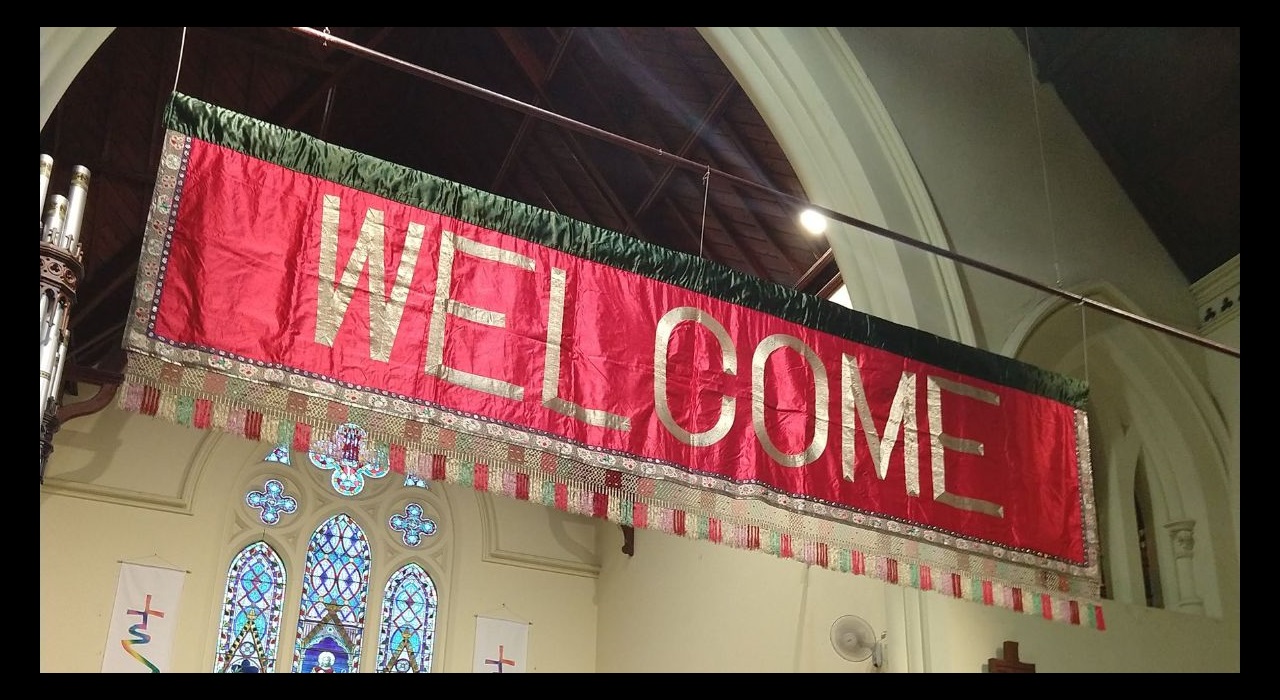Silk banner on display in Wesley Church that says Welcome