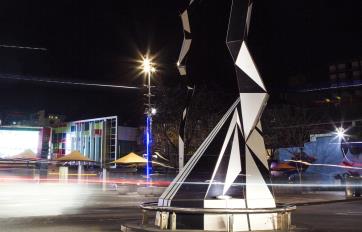 Modern sculpture in road in dark