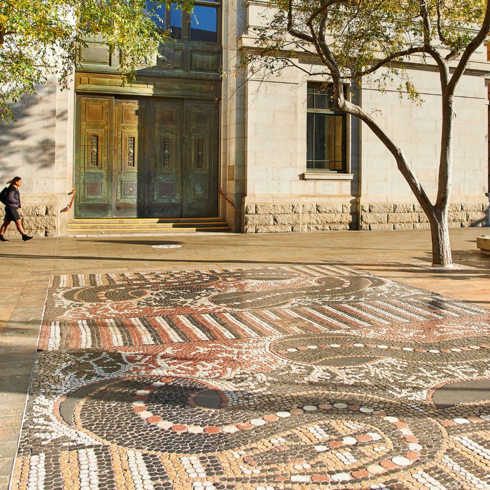 Large mosaic in Forrest Place featuring two snakes fighting