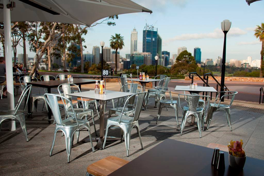 Cafe tables with city skyline in the background