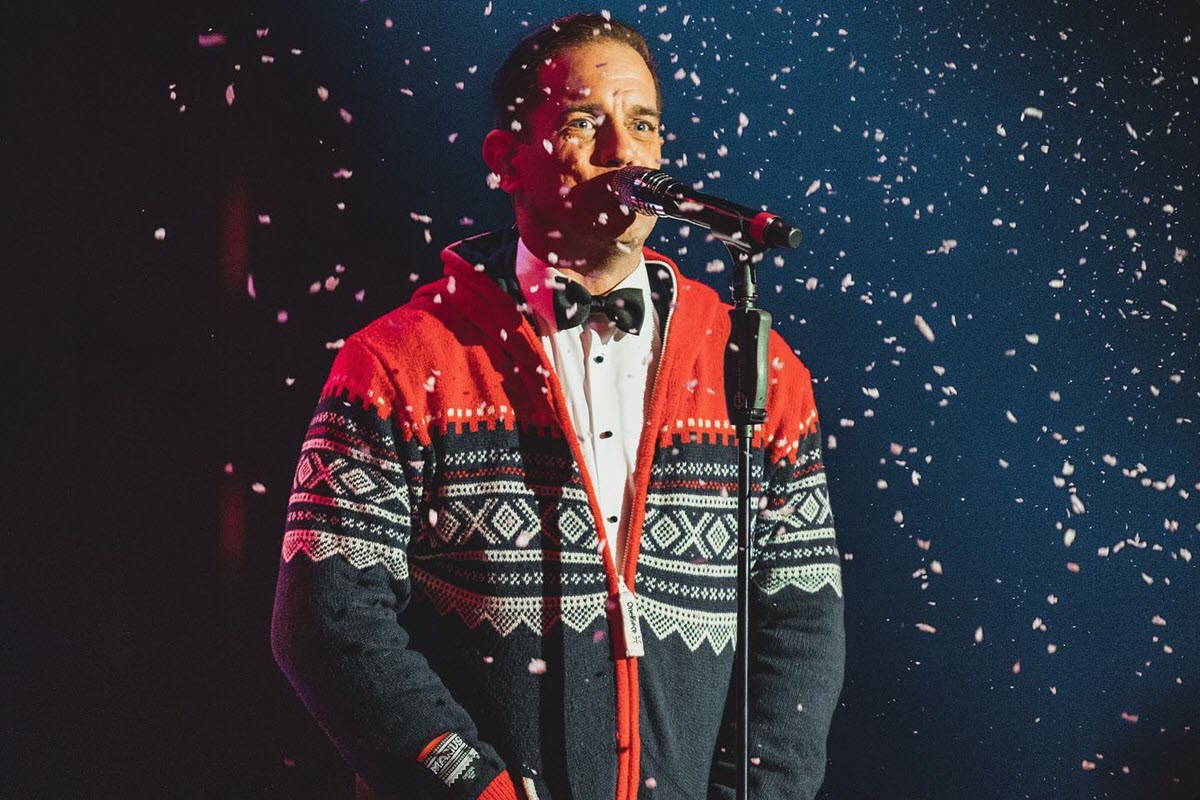 Man singing in Christmas jumper