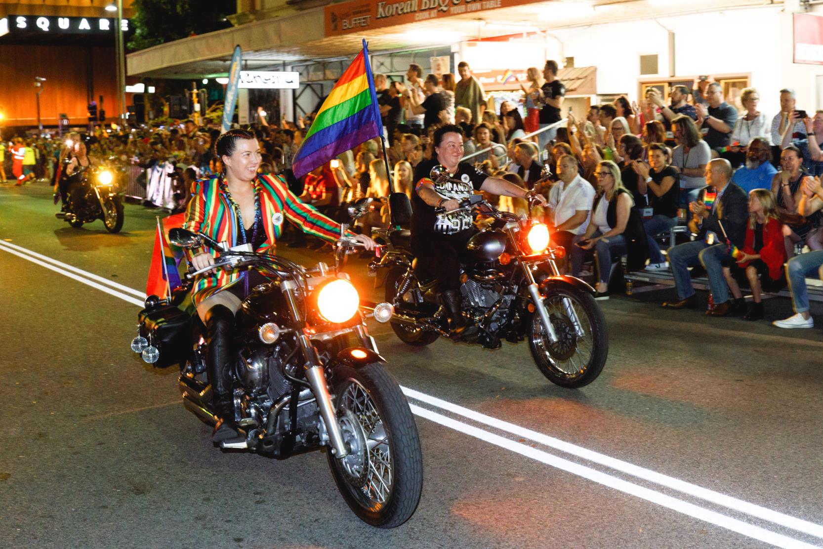 Dikes on Bikes opening Pride Parade on motorcycles with a Pride flag